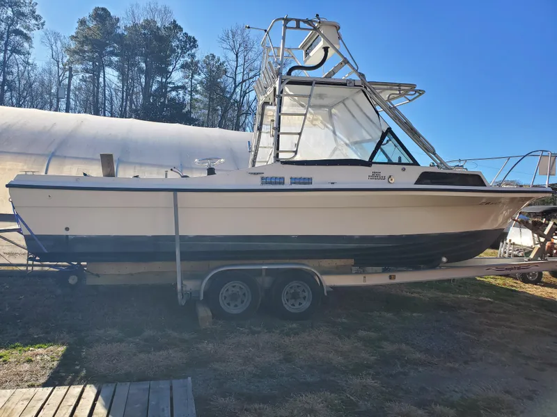 Slide: The Image of 1986 Sport-Craft Sportfisher boat on trailer, parked outdoors under clear blue sky. - 39