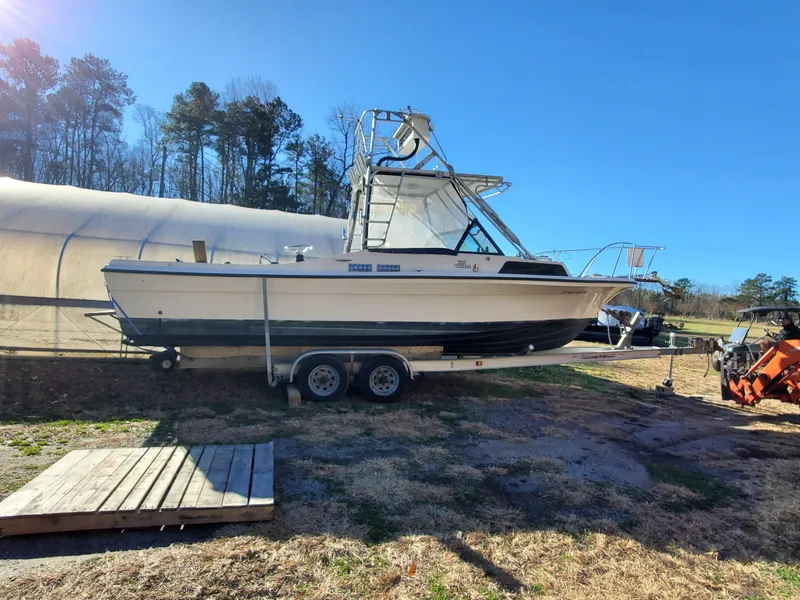 Slide: The Image of 1986 Sport-Craft Sportfisher boat on trailer, parked outdoors under clear blue sky. - 43