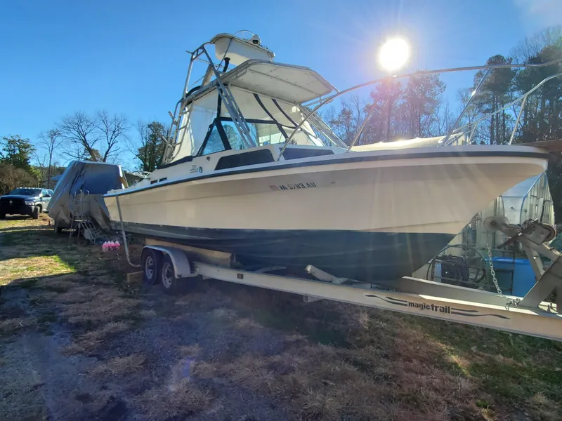 Slide: The Image of 1986 Sport-Craft Sportfisher boat on trailer under bright sunlight. - 45