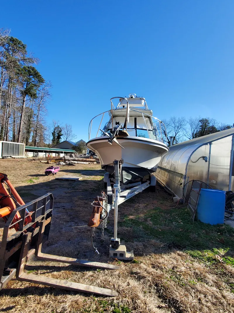 Slide: The Image of 1986 Sport-Craft Sportfisher boat on trailer in outdoor storage area. - 48
