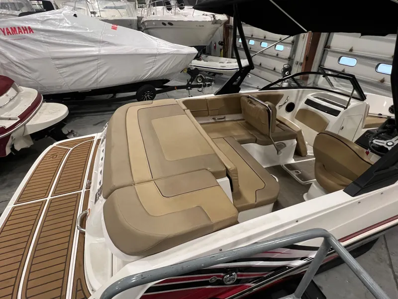 Slide: The Image of 2022 Bayliner VR5 Bowrider I/O with tan seating in a showroom. - 17