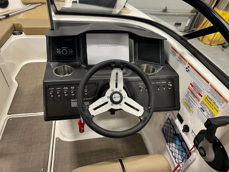 Slide: The Image of 2022 Bayliner VR5 Bowrider I/O dashboard with steering wheel and control panel. - 19