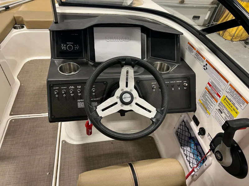 Slide: The Image of 2022 Bayliner VR5 Bowrider I/O dashboard with steering wheel and control panel. - 20