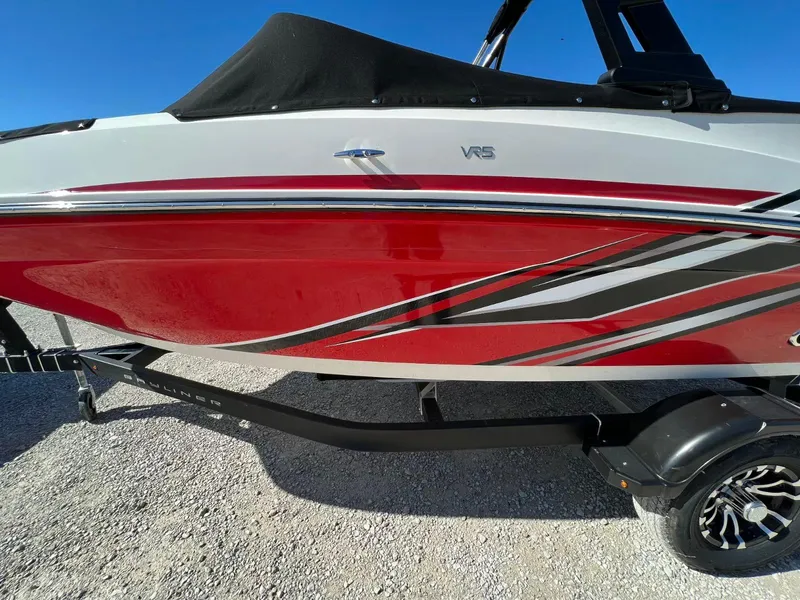 Slide: The Image of 2022 Bayliner VR5 Bowrider I/O with red and white design on a trailer. - 3