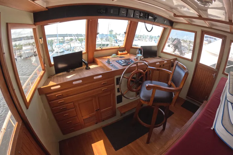 Slide: The Image of Interior helm of 1988 Kadey-Krogen 42 yacht with wooden finish and steering wheel. - 16