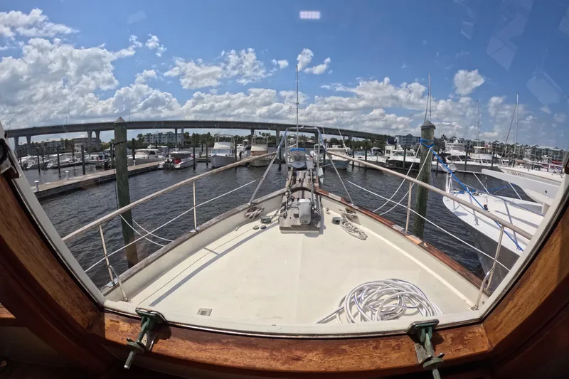 Slide: The Image of View from the bow of a 1988 Kadey-Krogen 42 yacht at a marina. - 19