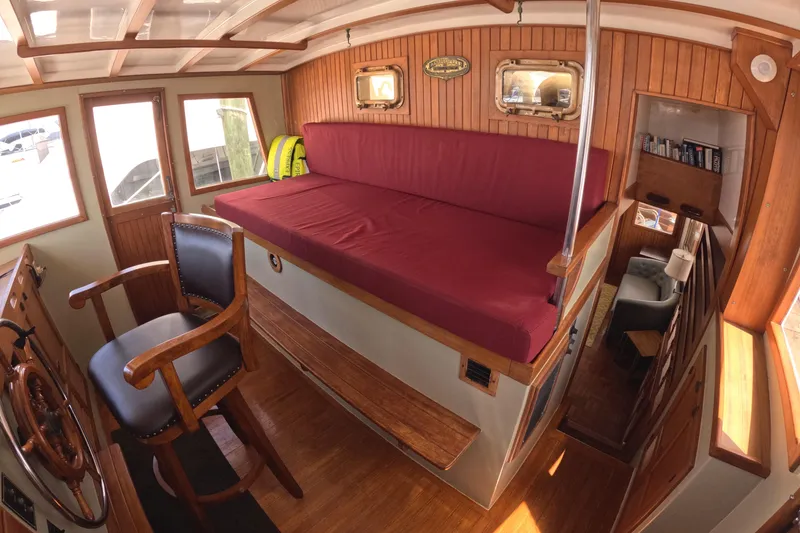 Slide: The Image of Interior of 1988 Kadey-Krogen 42 boat with wooden paneling and maroon seating. - 20