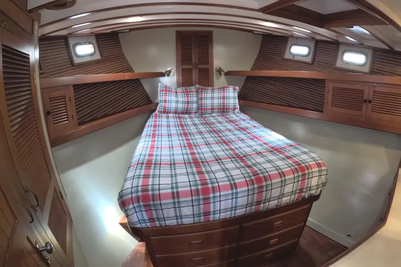 Slide: The Image of Cozy cabin bedroom in 1988 Kadey-Krogen 42 yacht with plaid bedding and wooden accents. - 22