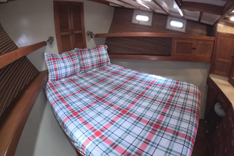 Slide: The Image of Cozy cabin interior of 1988 Kadey-Krogen 42 with plaid bedding and wooden accents. - 23