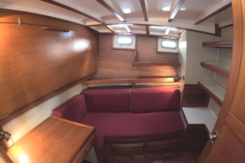 Slide: The Image of Interior of 1988 Kadey-Krogen 42 yacht with wooden furnishings and red seating. - 27