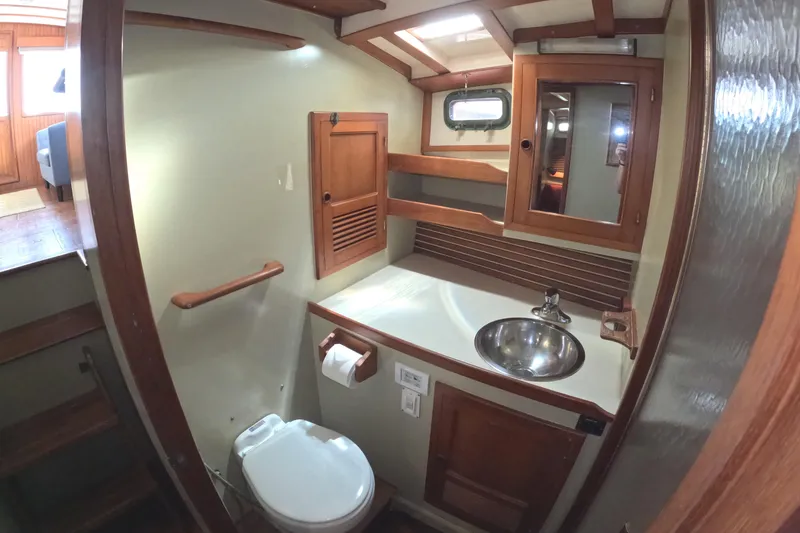 Slide: The Image of 1988 Kadey-Krogen 42 yacht bathroom with wooden cabinetry and stainless steel sink. - 29