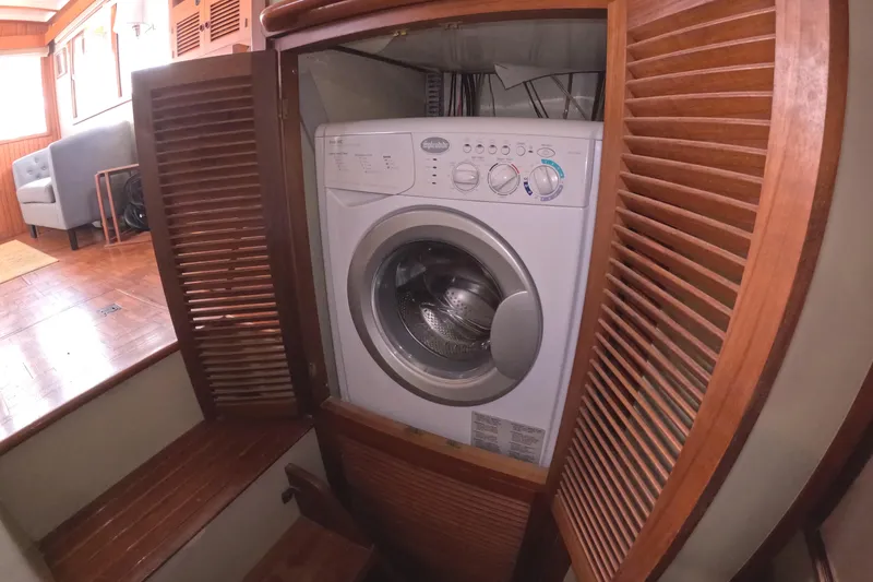 Slide: The Image of Washing machine inside 1988 Kadey-Krogen 42 yacht with wooden cabinetry. - 31