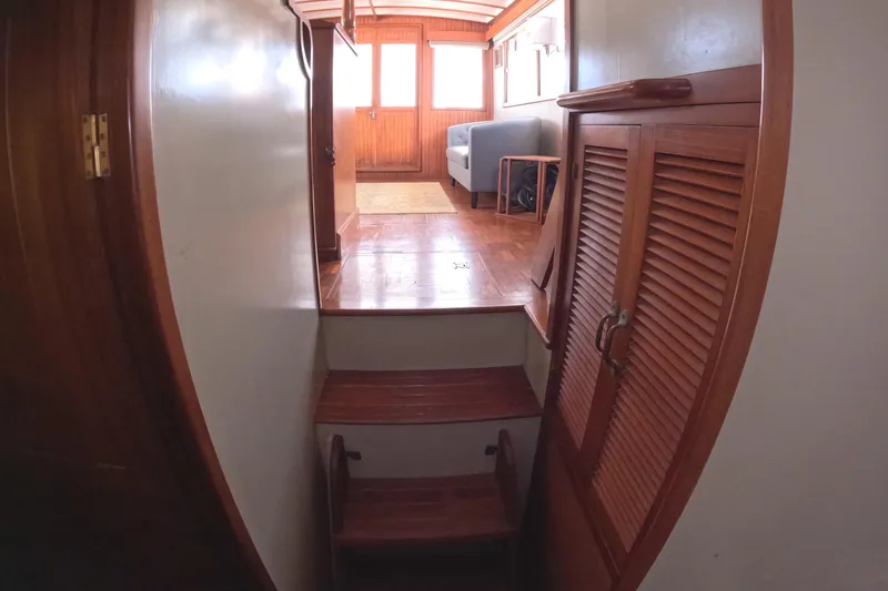 Slide: The Image of Interior of 1988 Kadey-Krogen 42 yacht with wooden stairs and cabinets. - 32
