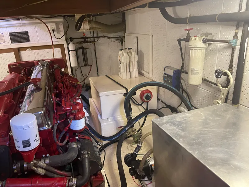 Slide: The Image of Engine room of 1988 Kadey-Krogen 42 with red engine and various mechanical components. - 33