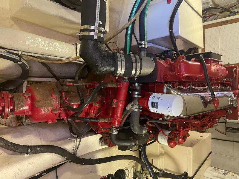 Slide: The Image of Engine of a 1988 Kadey-Krogen 42 boat, featuring red components and black hoses. - 35