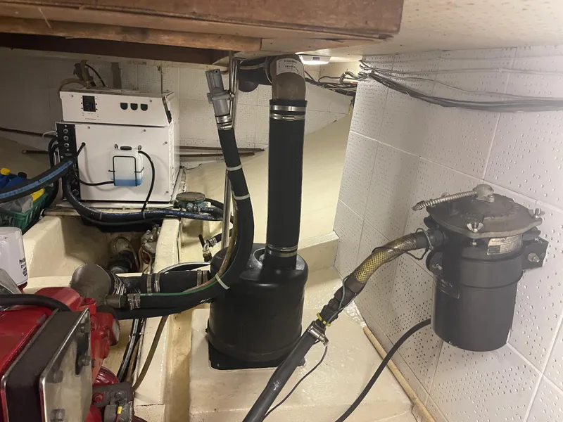 Slide: The Image of Engine room of a 1988 Kadey-Krogen 42 boat, showcasing mechanical components and wiring. - 38