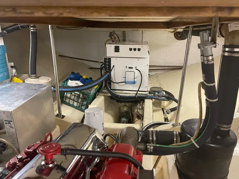 Slide: The Image of Engine room of a 1988 Kadey-Krogen 42 boat, featuring mechanical components and storage. - 39