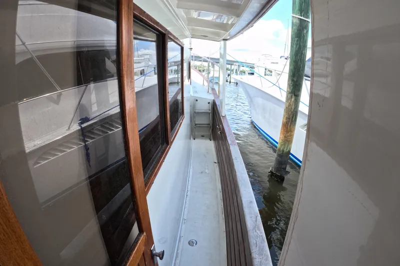Slide: The Image of 1988 Kadey-Krogen 42 yacht side deck with wooden accents, docked at marina. - 40