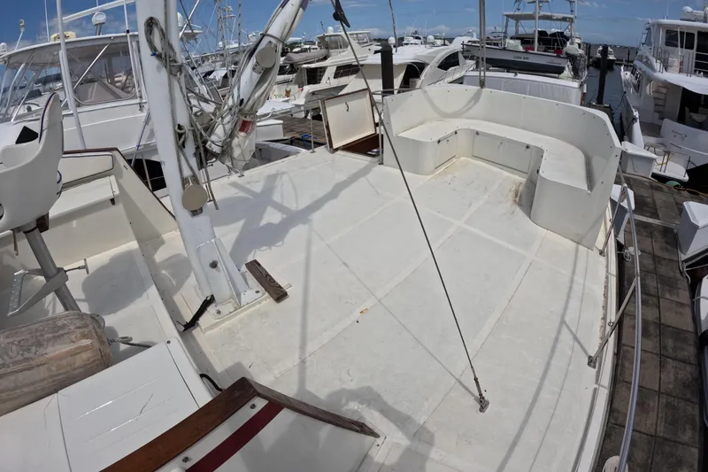 Slide: The Image of 1988 Kadey-Krogen 42 yacht deck with seating, docked among other boats. - 45