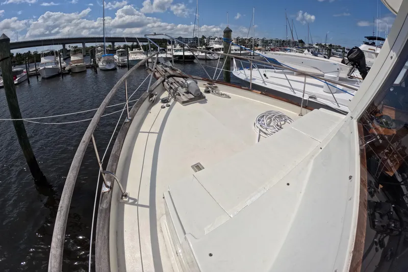 Slide: The Image of 1988 Kadey-Krogen 42 yacht docked at marina under blue sky. - 48