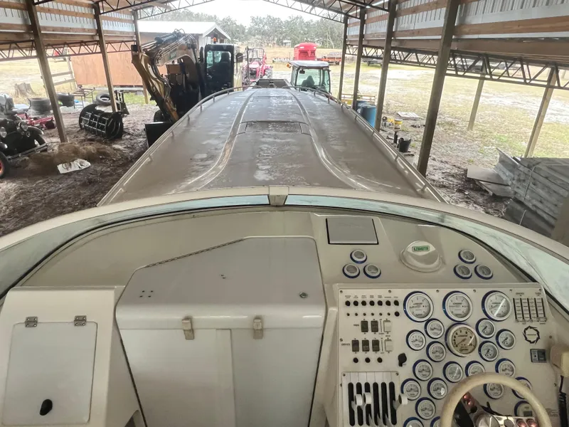 Slide: The Image of 1997 Fountain 47' Lightning boat dashboard in covered storage area. - 12