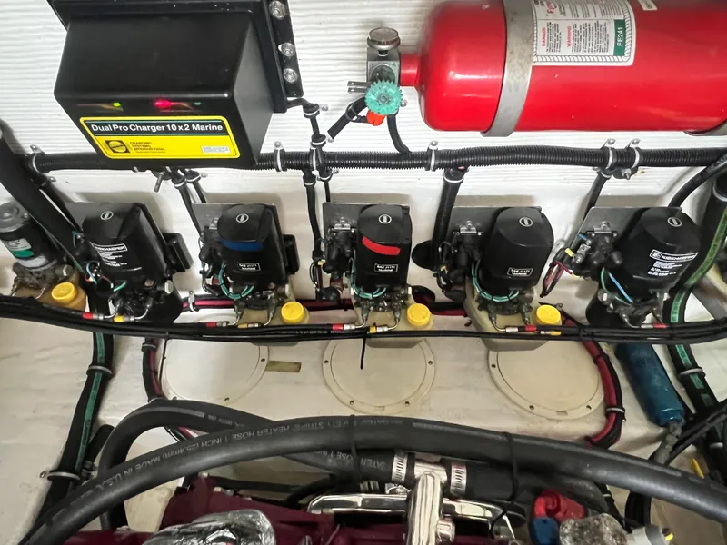 Slide: The Image of Engine compartment of a 1997 Fountain 47' Lightning boat with fire extinguisher and battery chargers. - 16