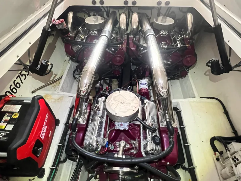 Slide: The Image of Engine compartment of a 1997 Fountain 47' Lightning boat, featuring dual high-performance engines. - 22