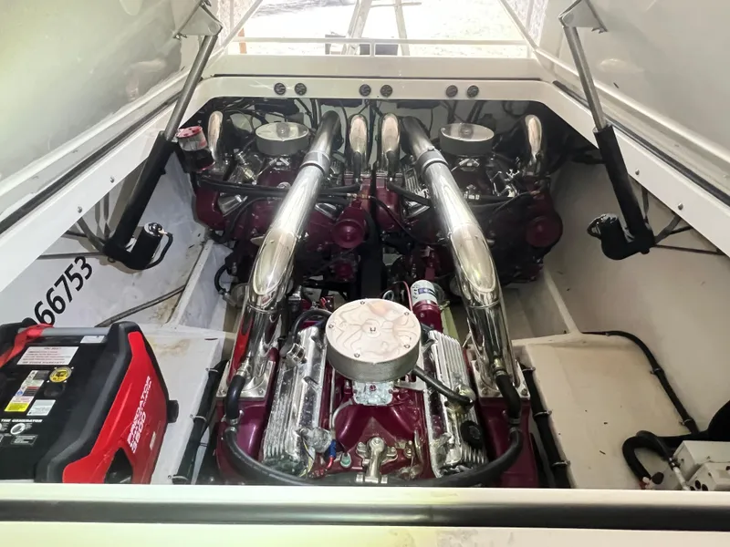 Slide: The Image of Engine compartment of a 1997 Fountain 47' Lightning boat, showcasing powerful dual engines. - 26