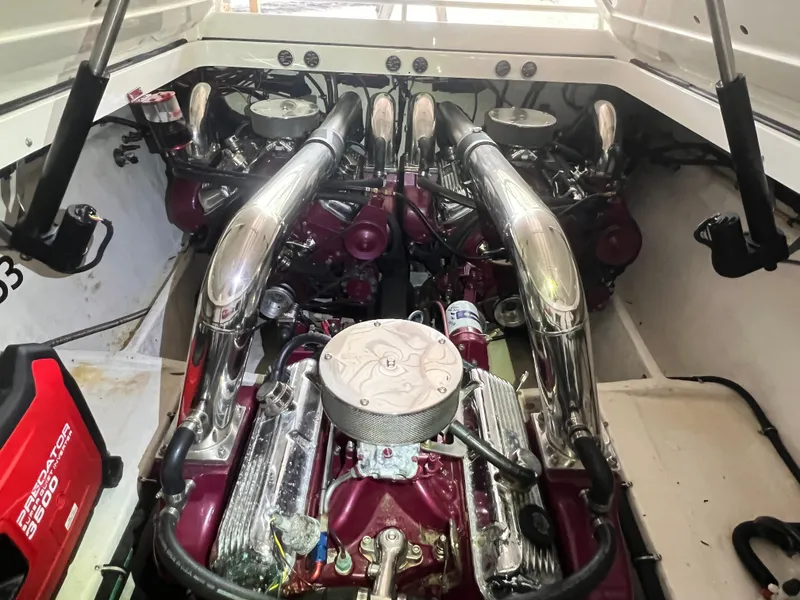 Slide: The Image of Engine compartment of a 1997 Fountain 47' Lightning boat, showcasing powerful dual engines. - 27