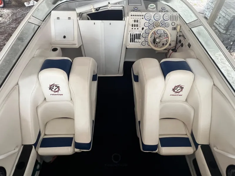 Slide: The Image of Interior of 1997 Fountain 47' Lightning boat with white and blue seating. - 29
