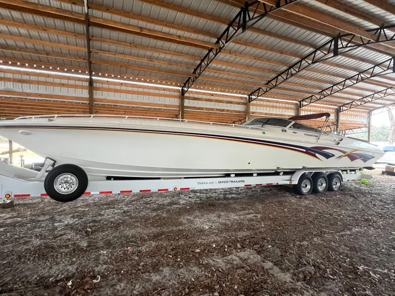 Slide: The Image of 1997 Fountain 47' Lightning speedboat on trailer in covered storage. - 3