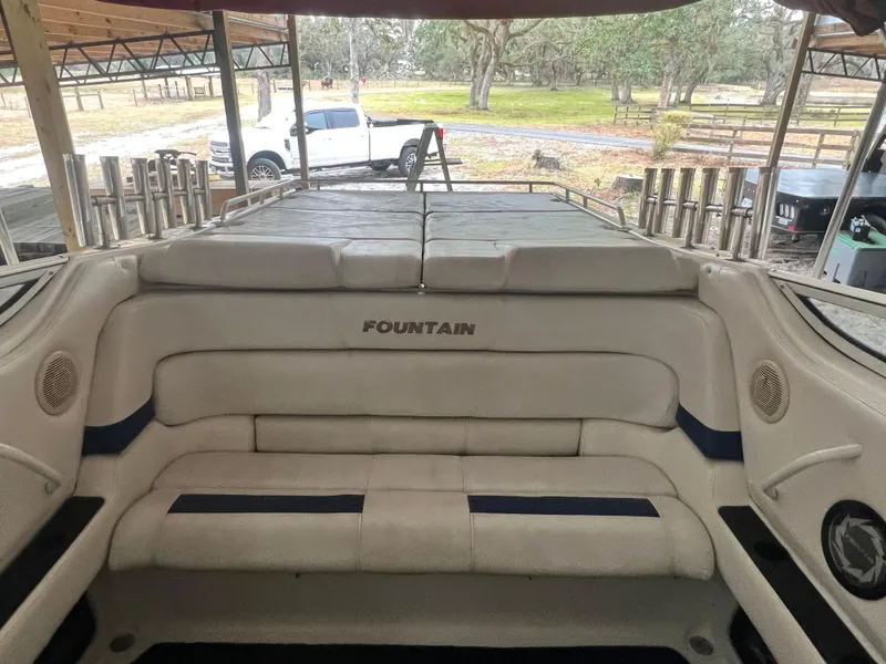 Slide: The Image of 1997 Fountain 47' Lightning boat interior with cushioned seating and logo. - 30
