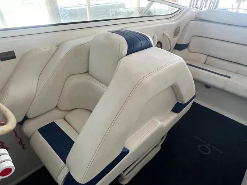 Slide: The Image of Interior of 1997 Fountain 47' Lightning boat with white and blue seating. - 34