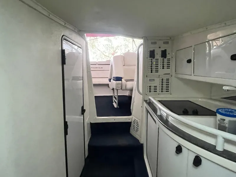 Slide: The Image of Interior of 1997 Fountain 47' Lightning boat with white cabinetry and seating. - 37