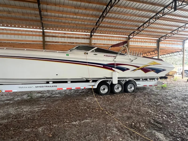 Slide: The Image of 1997 Fountain 47' Lightning boat on trailer in covered storage. - 4