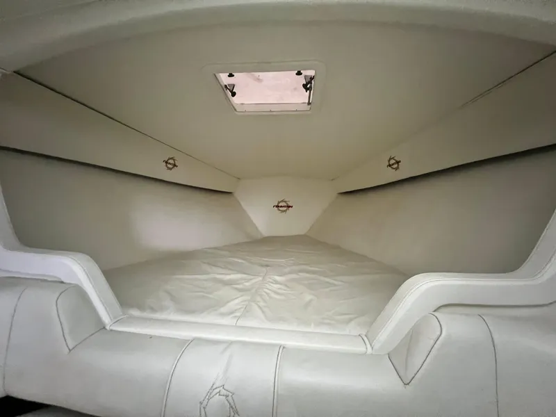 Slide: The Image of Interior cabin of 1997 Fountain 47' Lightning boat, featuring white upholstery. - 41