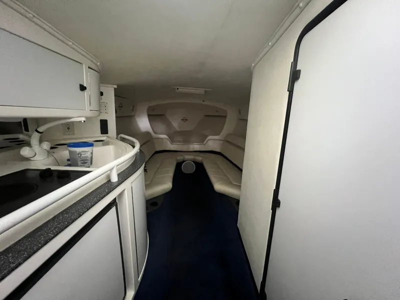 Slide: The Image of Interior of a 1997 Fountain 47' Lightning boat, featuring seating and cabinetry. - 45