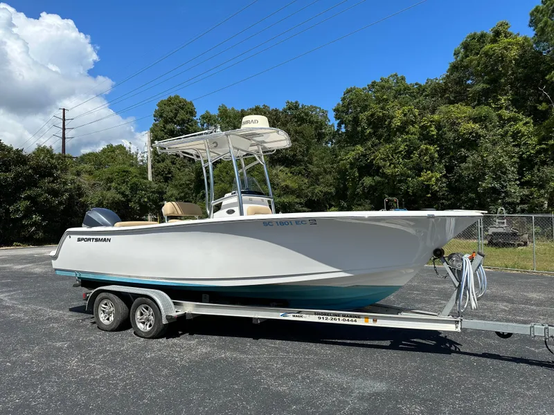 Slide: The Image of 2016 Sportsman Open 232 Center Console boat on trailer, parked outdoors. - 0