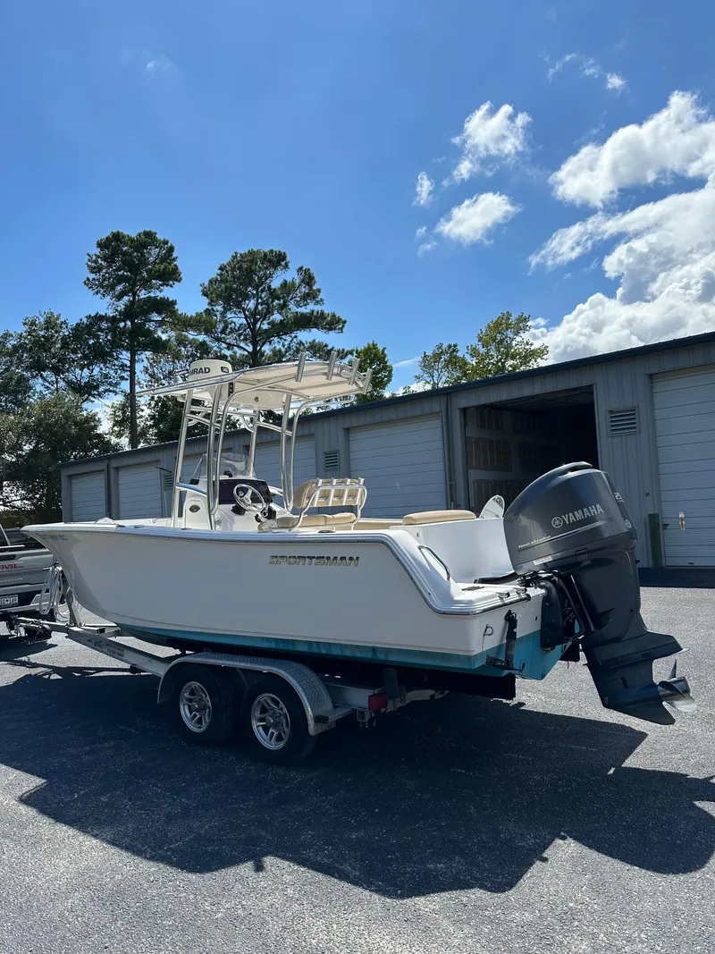 Slide: The Image of 2016 Sportsman Open 232 Center Console boat on trailer, parked outdoors. - 3