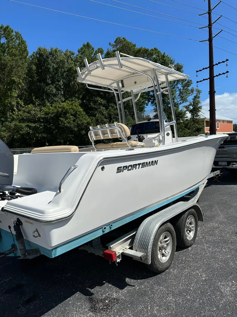 Slide: The Image of 2016 Sportsman Open 232 Center Console boat on trailer, parked outdoors. - 5