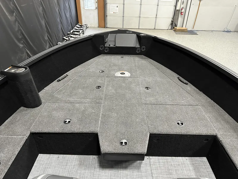 Slide: The Image of 2025 Alumacraft Competitor 185X Tiller boat interior with spacious deck and storage compartments. - 10