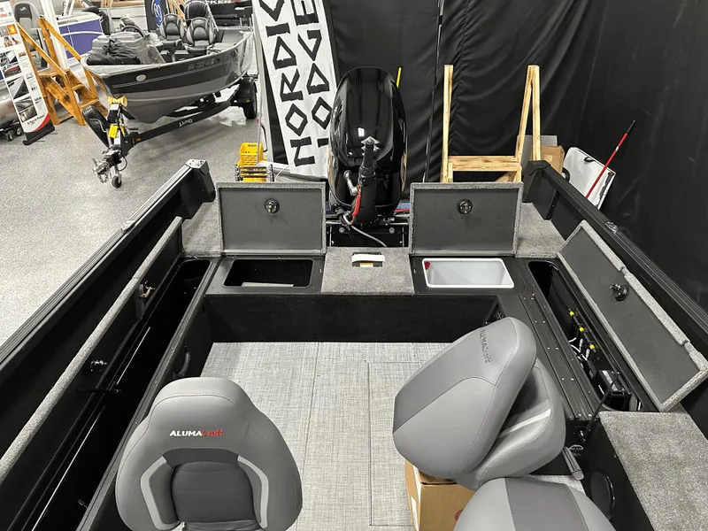 Slide: The Image of 2025 Alumacraft Competitor 185X Tiller boat interior with seating and storage compartments. - 14
