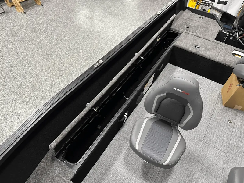 Slide: The Image of 2025 Alumacraft Competitor 185X Tiller interior with seating and storage compartments. - 16