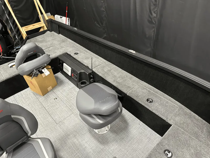 Slide: The Image of 2025 Alumacraft Competitor 185X Tiller interior with gray seating and control panel. - 17