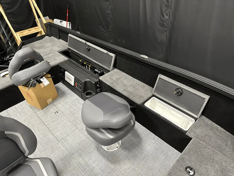 Slide: The Image of 2025 Alumacraft Competitor 185X Tiller interior with seating and storage compartments. - 18