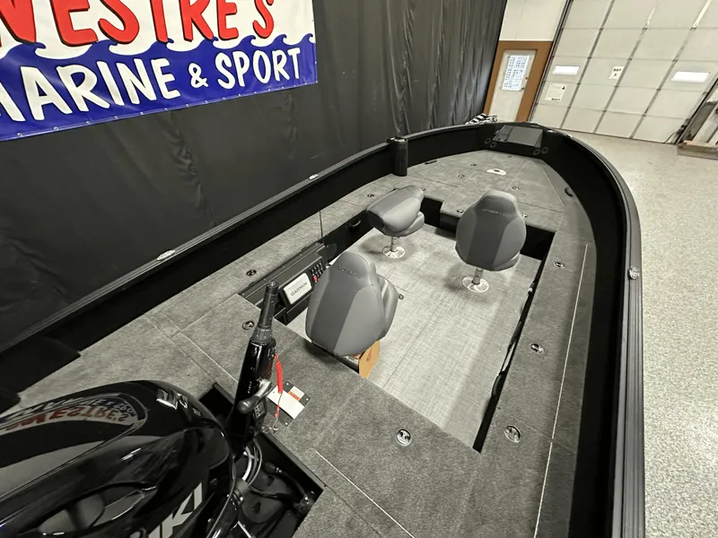 Slide: The Image of 2025 Alumacraft Competitor 185X Tiller boat interior with seating and control panel. - 22