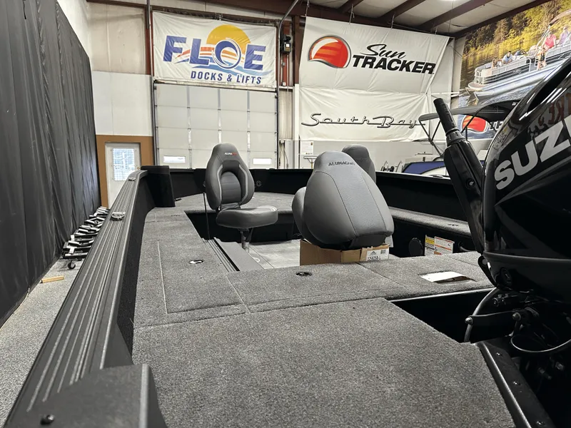 Slide: The Image of 2025 Alumacraft Competitor 185X Tiller boat interior with seating and Suzuki engine. - 23