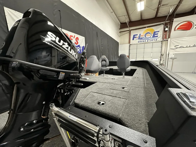 Slide: The Image of 2025 Alumacraft Competitor 185X Tiller boat with Suzuki engine in showroom. - 24