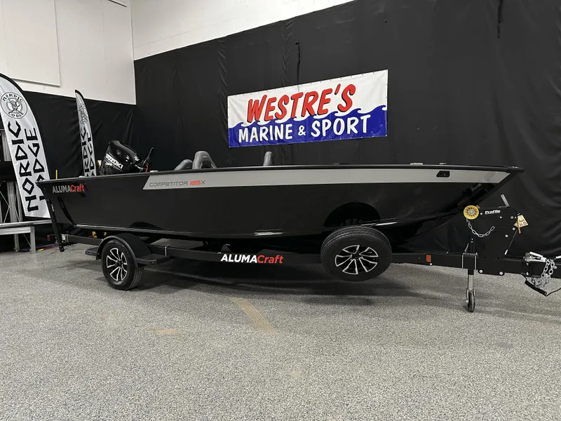 Slide: The Image of 2025 Alumacraft Competitor 185X Tiller boat displayed at Westre's Marine & Sport showroom. - 4