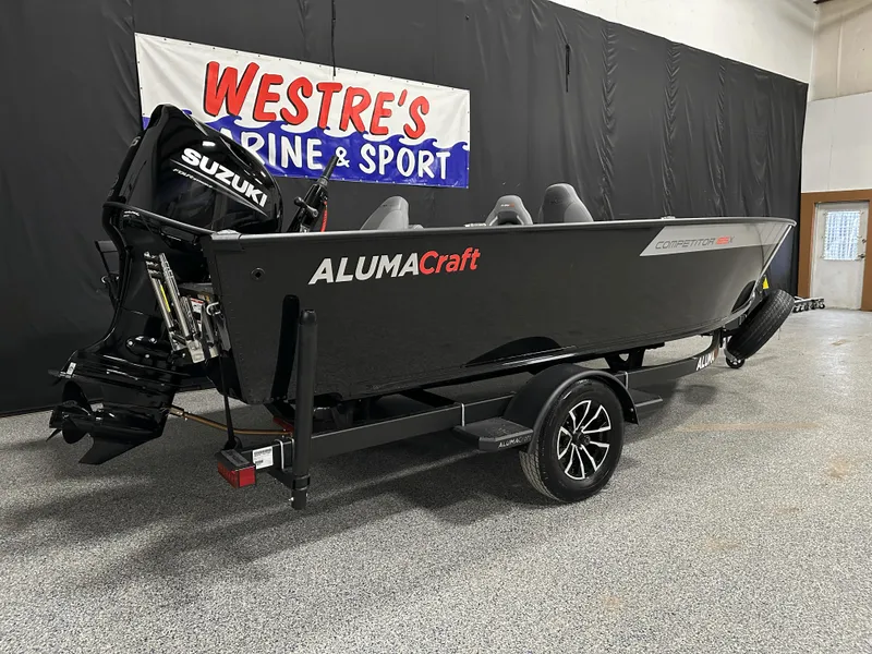 Slide: The Image of 2025 Alumacraft Competitor 185X Tiller boat with Suzuki motor on display in showroom. - 5